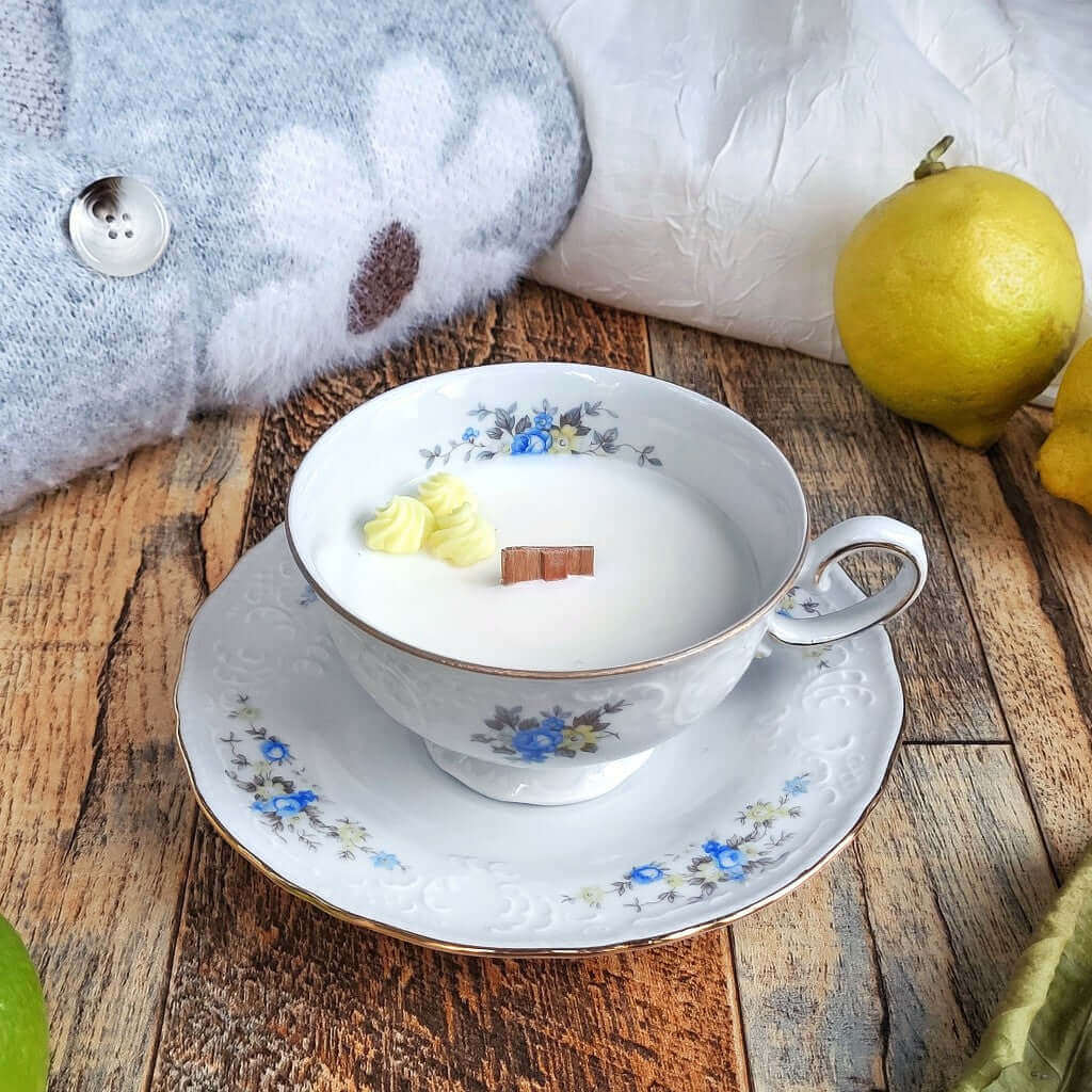 Candela in cera di soia in una tazza di porcellana Bavaria, decorata con meringhe gialle di cera