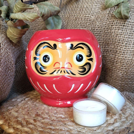 Bruciatore o bruciaessenze per tart profumate in ceramica con desing unico a forma di bambola daruma giapponese.