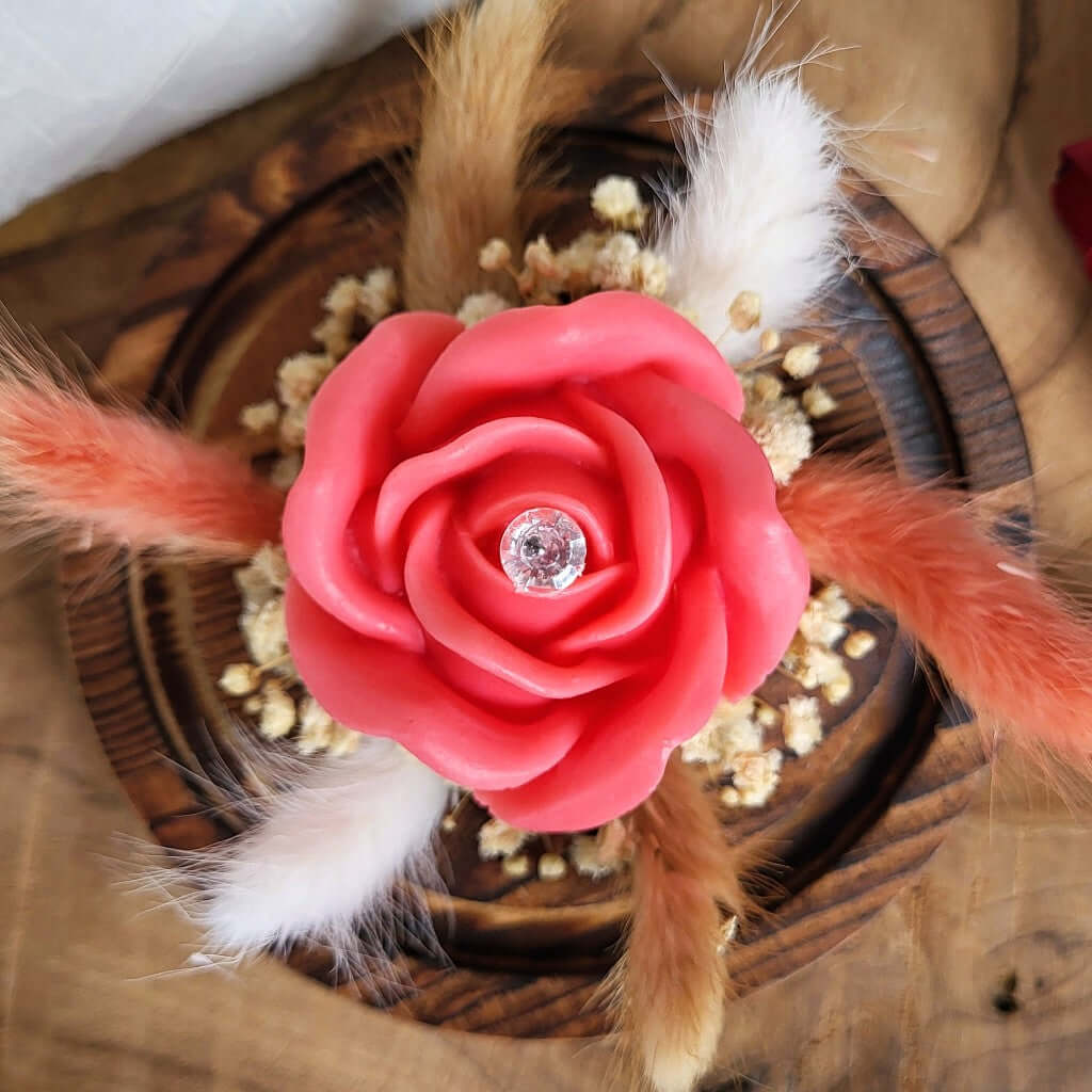 Candela profumata in cera di soia a forma di rosa con al centro un diamante. È realizzata in stile bouquet, con decorazioni pampas e fiori da sposa, all'interno di una campana in vetro trasparente con cuore e base in legno. Idea Regalo Festa della Mamma 